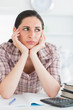Upset woman with books and calculator