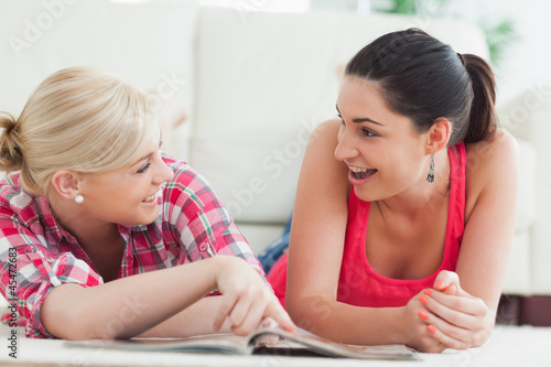 Photo: Women lying on the floor talking Women lying on the floor talking