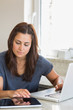 Photo: Brunette typing on the tablet pc and laptop Brunette typing on the tablet pc and laptop