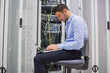 Foto: Man trying to find a solution for servers Man trying to find a solution for servers
