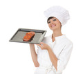 smiling cook girl showing raw meat