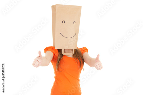 Photo: girl in smiling paper bag on head with thumbs up girl in smiling paper bag on head with thumbs up