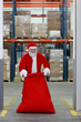 Photo: Santa Claus with large red sack in the gate to storehouse Santa Claus with large red sack in the gate to storehouse