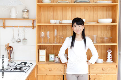 Photo: a young asian woman in the kitchen a young asian woman in the kitchen