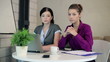 Video: Serious businesswomen with laptop looking to camera in office Serious businesswomen with laptop looking to camera in office
