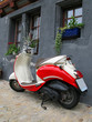 Trendy moped against old building. Fribourg, Switzerland