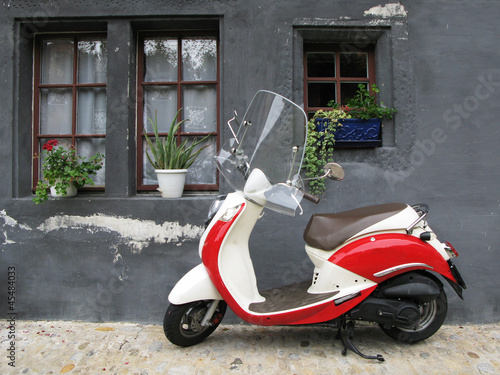 Photo: Trendy moped against old house. Fribourg, Switzerland Trendy moped against old house. Fribourg, Switzerland