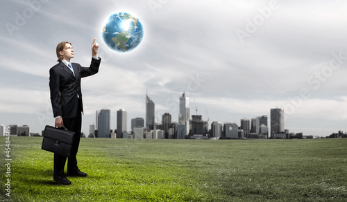 Photo: Businessman holding the world Businessman holding the world