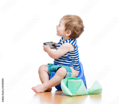 Photo: funny baby sitting on chamber pot with pda and toilet paper roll funny baby sitting on chamber pot with pda and toilet paper roll