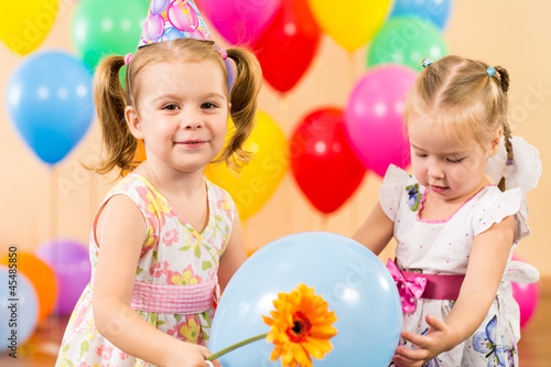 Photo: pretty children with colorful balloons and gifts on birthday par pretty children with colorful balloons and gifts on birthday par