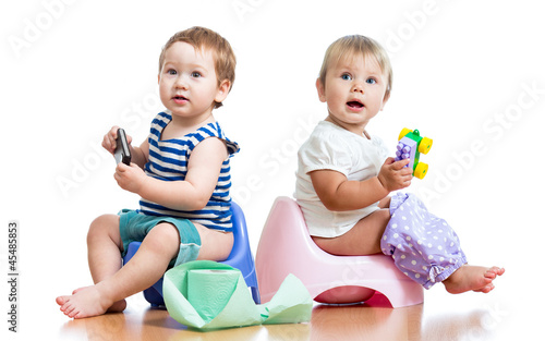 Photo: babies toddlers sitting on chamber pot and playing with toys babies toddlers sitting on chamber pot and playing with toys