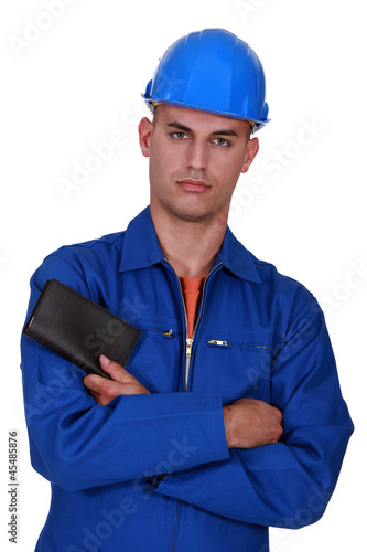 Photo: construction worker with folded arms holding wallet construction worker with folded arms holding wallet