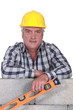 craftsman holding a level