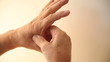 man rubs the painful area between his index finger and thumb