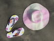 Flip-flops and hat on the black sand of Tenerife island, Canarie