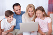 Happy Family Using Laptop