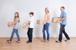 Parents And Two Children With Cardboard Boxes