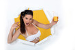 Woman in a bikini with a glass of orange juice