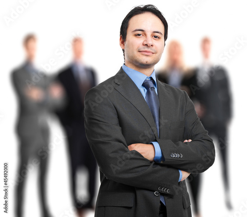 Photo: Businessman in front of his team Businessman in front of his team