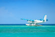 seaplane taking off over turquoise ocean 