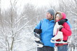 Young couple carrying ice skates