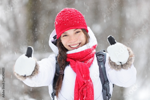 Photo: Happy woman in snowstorm giving thumbs up Happy woman in snowstorm giving thumbs up
