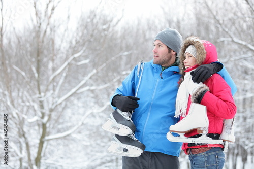 Photo: Young couple carrying ice skates Young couple carrying ice skates