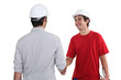 Construction workers shaking hands