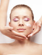 Pretty young women receives a face treatment  - isolated