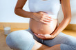Beautiful pregnant woman massage her belly