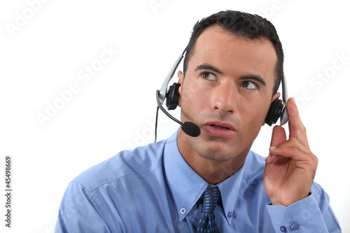 Photo: Man speaking into a hands-free headset Man speaking into a hands-free headset