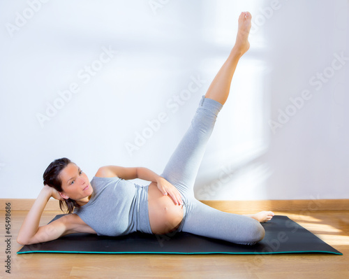 Photo: Beautiful pregnant woman gym fitness exercise Beautiful pregnant woman gym fitness exercise