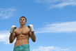 Athletic young man in boxing gloves
