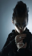 Portrait of a young female vampire on a dark background