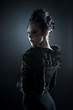 Portrait of a young female vampire on a dark background