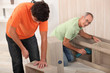Father and son putting together flat pack furniture