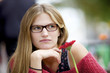 Pensive woman with glasses