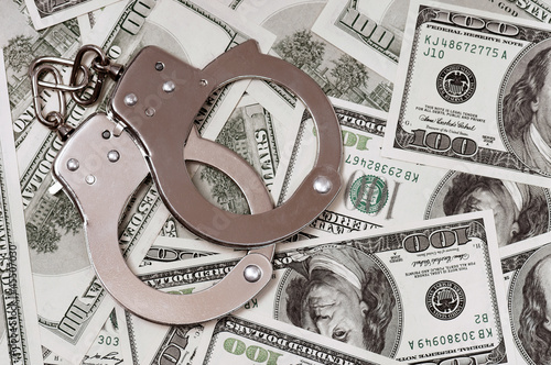 Photo: Dollars and handcuffs Dollars and handcuffs