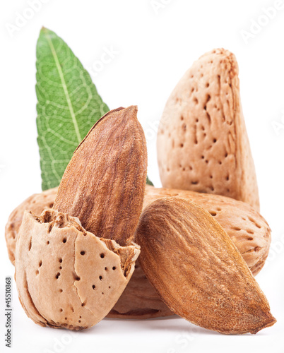 Photo: Almond nuts with leaves. Isolated on a white Almond nuts with leaves. Isolated on a white