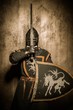 Medieval knight  holding sword in front of his face