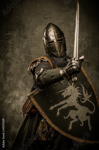 Photo: Medieval knight on grey background Medieval knight on grey background