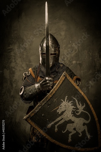 Photo: Medieval knight on grey background Medieval knight on grey background