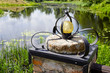 original lamp on millstone near pond