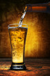 beer pouring from beer bottle to glass