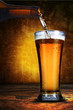 Beer pouring from beer bottle to glass