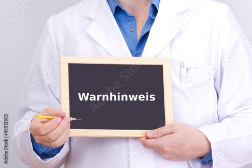 Photo: Doctor shows information on blackboard: warning Doctor shows information on blackboard: warning