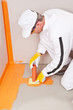 plumber applied waterproofing cuff on the floor of the bathroom