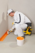 worker brush waterproofing around the wall and floor