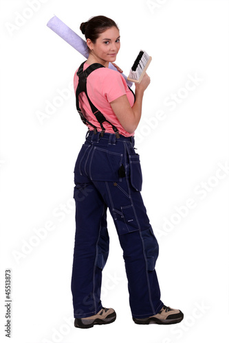 Photo: Woman hanging wallpaper Woman hanging wallpaper
