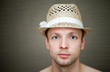 Young man in a fun straw hat